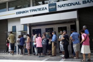 ATHENS, GREECE - JUNE 27: Greeks queue in front of the National Bank to use ATM to withdraw cash as Parliament holds an emergency session for the government's proposed referendum June 27, 2015 in Athens, Greece. Greece's fraught bailout talks with its creditors took a dramatic turn early Saturday, with the radical left government announcing a referendum in just over a week on the latest proposed deal . (Photo by Milos Bicanski/Getty Images)